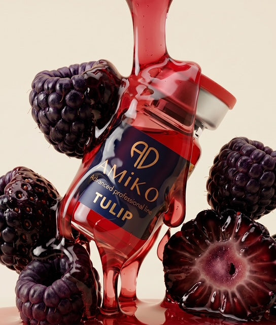 Amiko Tulip bottle surrounded by blackberries on a beige background
